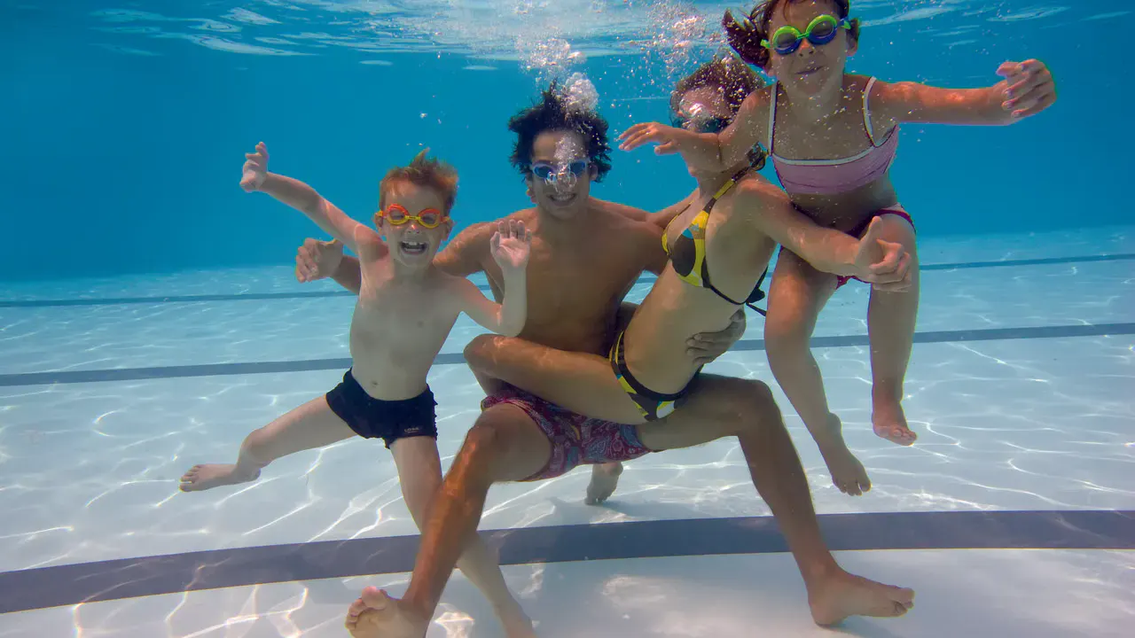 Eine Familie unter Wasser im Pool des H2O Hotel-Therme-Resorts